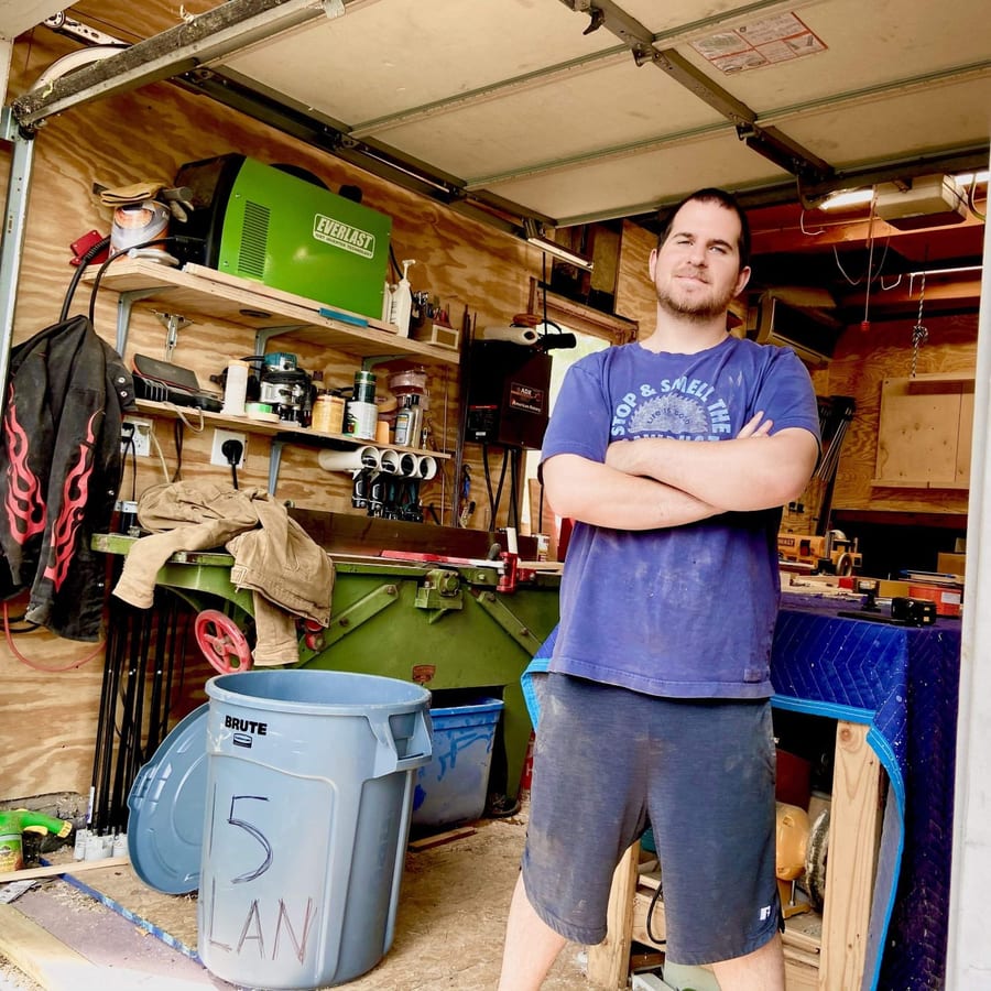 Max Grossman in his workshop, arms crossed