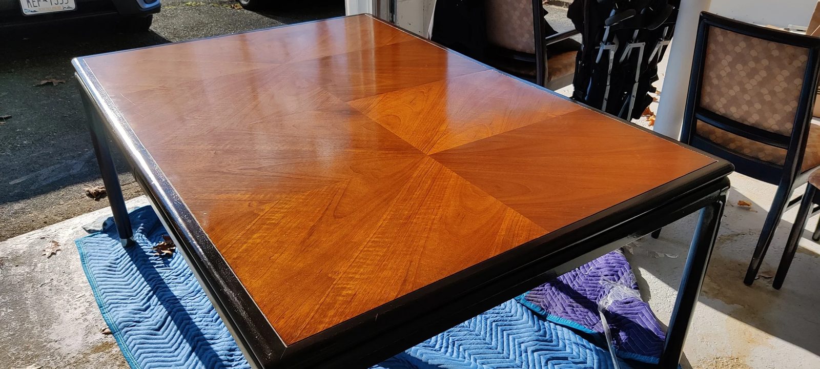 A refinished dining table with a freshly restored book-matched top