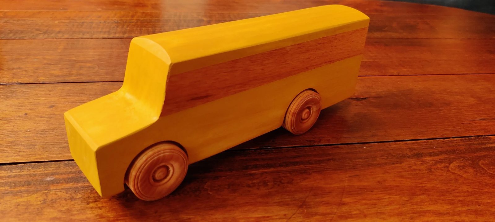A wooden toy with turned wheels