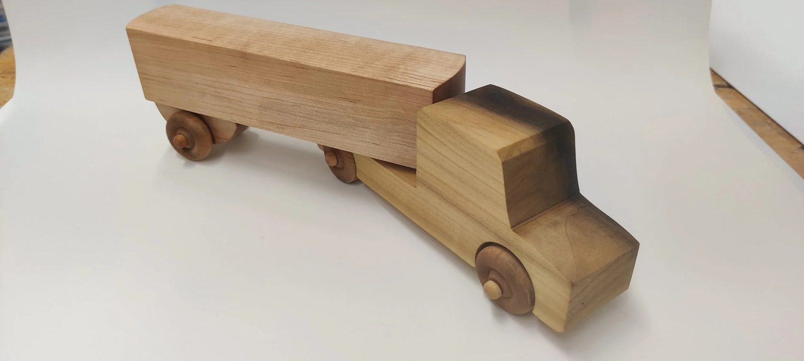 A handmade wooden toy car, side view