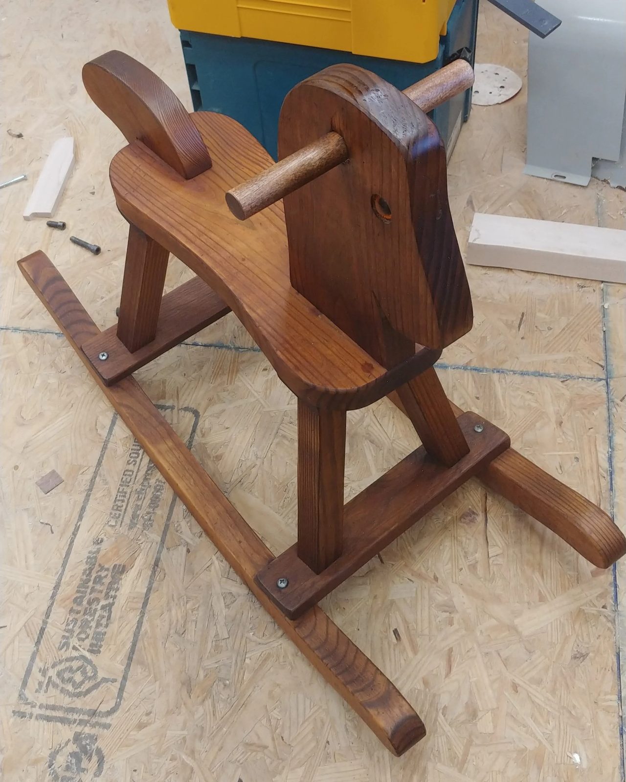A child's wooden rocking horse, repaired and refinished