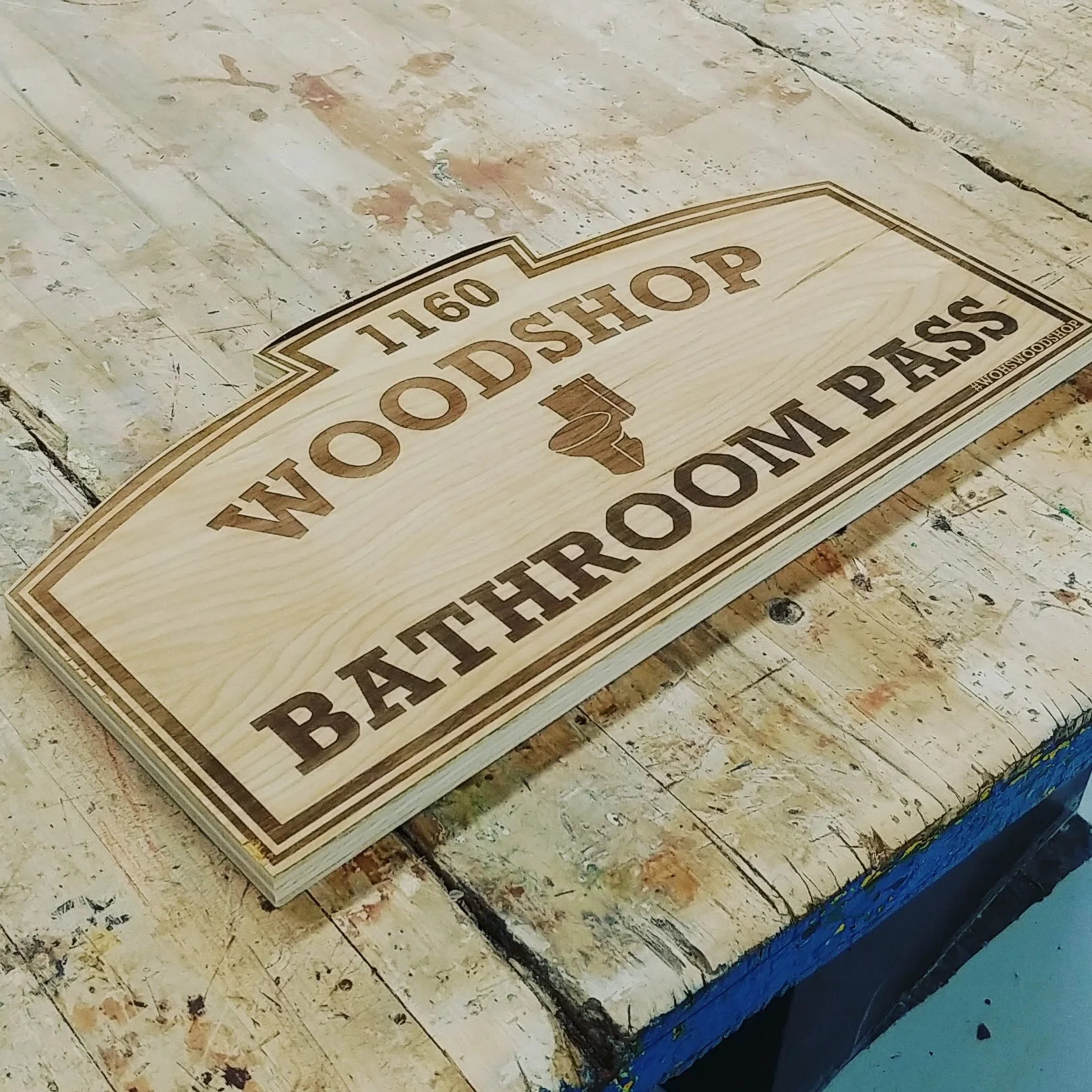 An engraved wooden shop sign