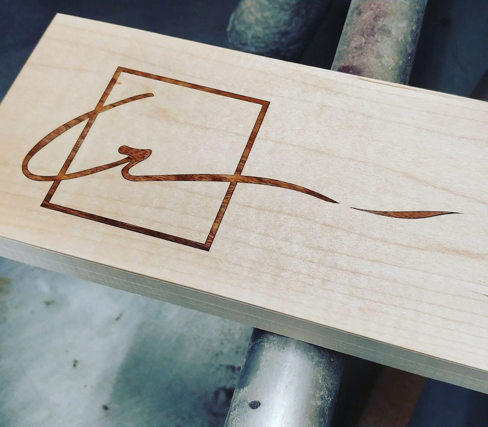A monogram engraved into a maple board