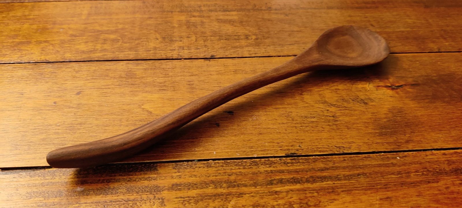 A hand-carved wooden spoon, bowl detail