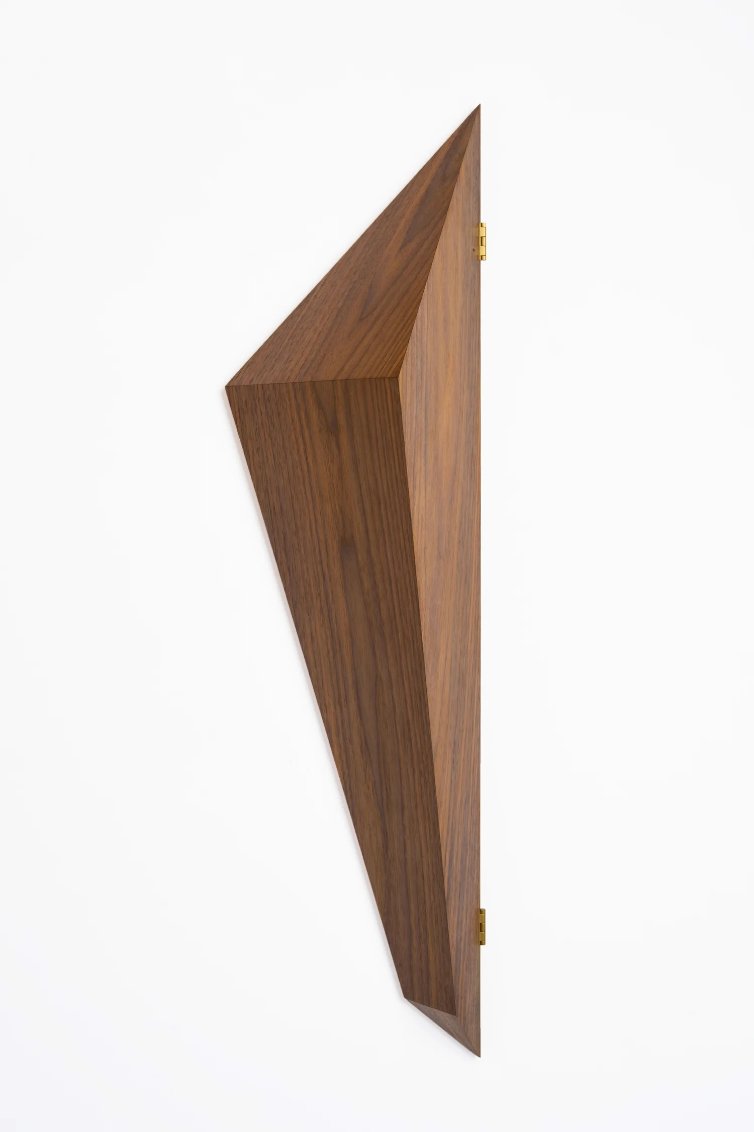 An angular walnut reliquary with brass hinges